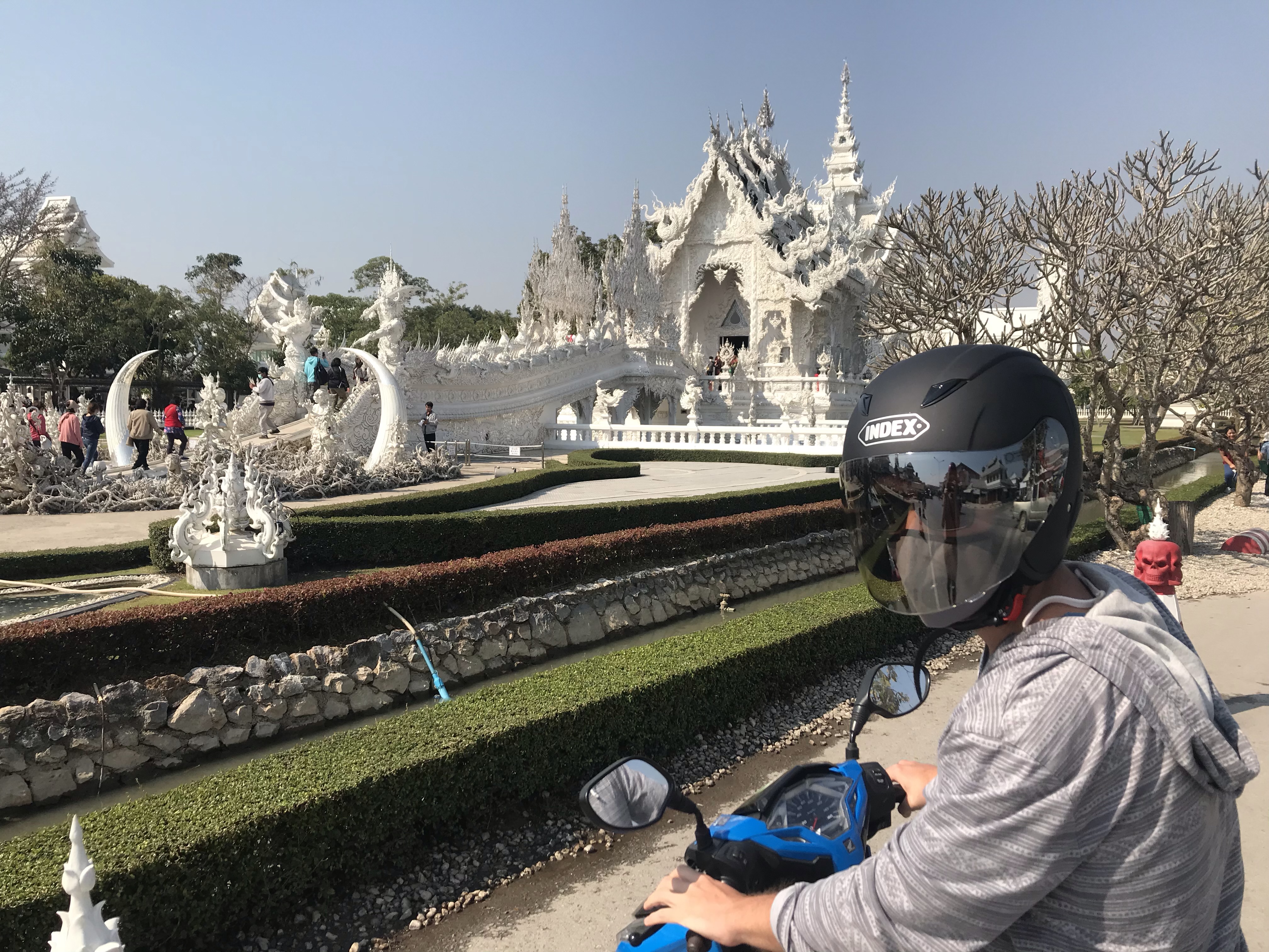 Scootering to the white temple in Thailand